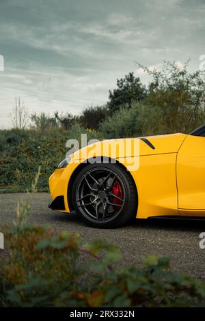 Toyota Supra sports car driving up the hill climb track at the Goodwood