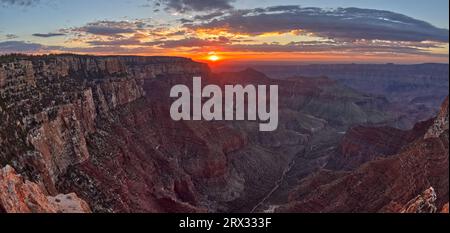 The sun rising at Grand Canyon North Rim, viewed from the Angels Window Overlook at Cape Royal, Grand Canyon National Park, Arizona Stock Photo