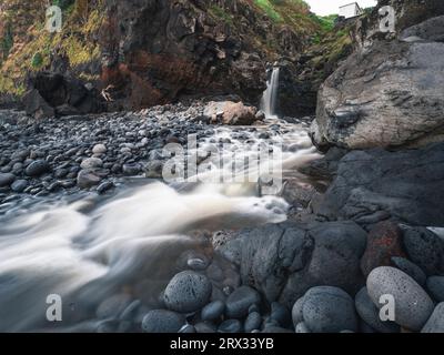 Long exposure of a waterfall falling into the ocean in Porto de Pescas da Achada on Sao Miguel island, Azores Islands, Portugal, Atlantic, Europe Stock Photo