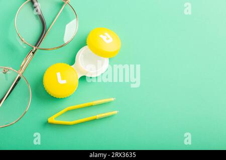 Eye lenses in a beautiful container, glasses and tweezers High quality photo Stock Photo