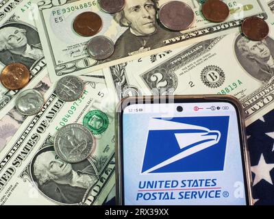 Germany. 22nd Sep, 2023. In this photo illustration, United States Postal Service, USPS logo seen displayed on a smartphone with United States Dollar Currencies on the table. Credit: SOPA Images Limited/Alamy Live News Stock Photo