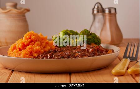 Minced beef and onion in gravy with mashed potatoes and broccoli. Stock Photo