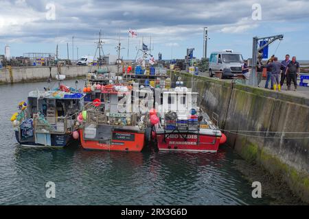 Seahouses, UK - 13 July, 2023: Fishing boats in Seahouses Harbour, Northumberland Stock Photo