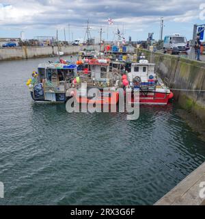 Seahouses, UK - 13 July, 2023: Fishing boats in Seahouses Harbour, Northumberland Stock Photo