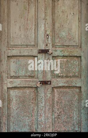 Weathered wooden door with flaking paintwork Stock Photo