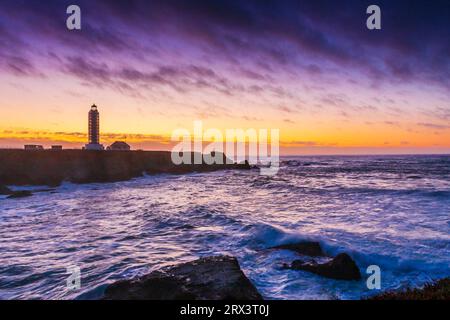 Point Arena Lighthouse at sunset, with storm coming in off the pacific ocean with high surf and crashing waves. The lighthouse is located on the Point Stock Photo