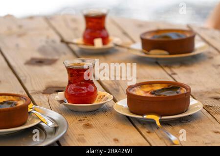 Turkish tea and rice pudding on the wood table Stock Photo