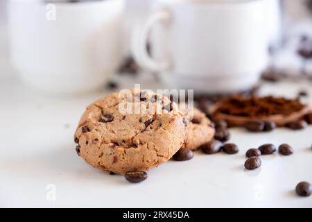 Two pieces of cookies with coffee set in the background Stock Photo