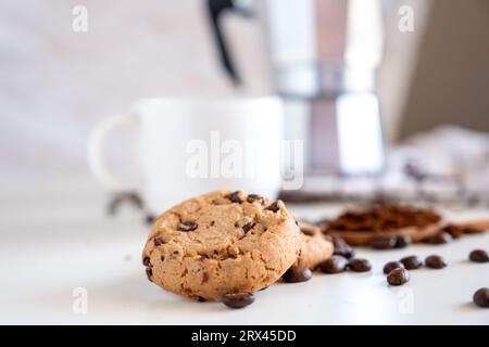 Two pieces of cookies with coffee set in the background Stock Photo