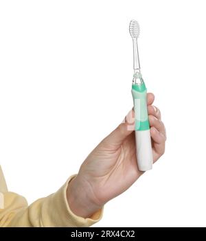 Woman holding electric toothbrush on white background, closeup Stock Photo