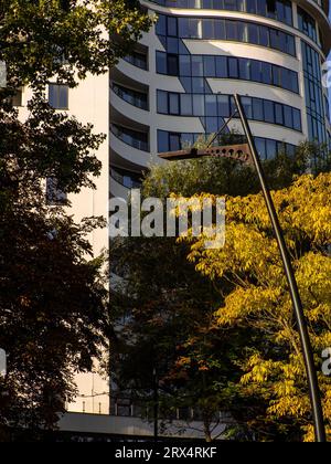 Luxury residential flat. Facade of a modern apartment building on a sunny day. House with a blue sky. Modern elements in contemporary architecture. Stock Photo