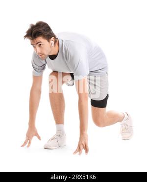 Sporty young man in starting position isolated on white background Stock Photo