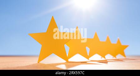 5 Five stars on table, blue sky background. five star icon for feedback review satisfaction service, Customer service experience and business satisfac Stock Photo