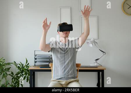 Young man testing his new application for vr headset Stock Photo