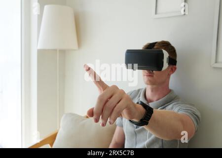 Software developer testing new application for vr headset he created Stock Photo