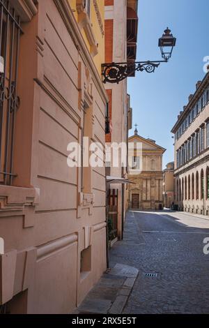 A Street in Parma and in the Background the deconsecrated Renaissance Church of San Marcellino, Italy. Stock Photo