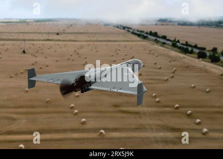 Military kamikaze drone flies over fields with hay countries, attack of unmanned aerial vehicles, war in Ukraine. Stock Photo