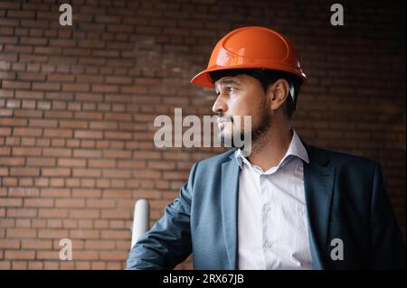 Contemplative engineer standing at construction site Stock Photo