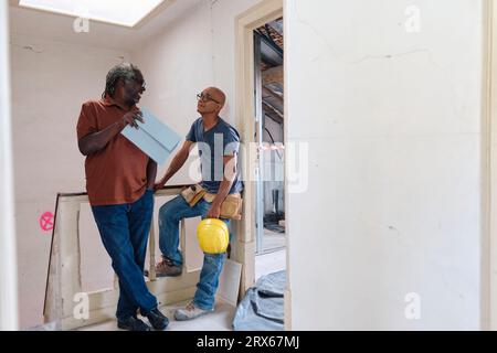 Architect and builder having discussion at site Stock Photo