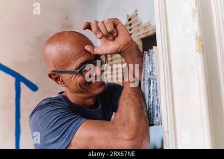 Happy construction worker with samples at site Stock Photo