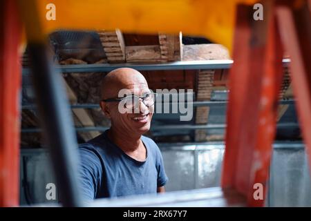 Happy construction worker wearing eyeglasses at site Stock Photo