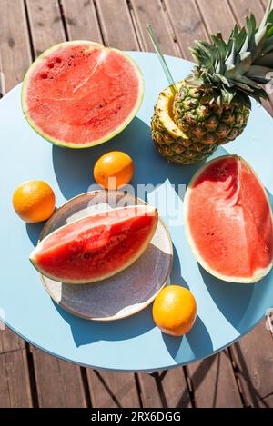 Slices of watermelon with oranges and pineapple on table Stock Photo