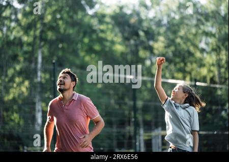 Cheerful father and son playing together in playground Stock Photo
