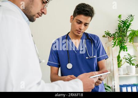 Two doctors using tablet PC together in clinic Stock Photo