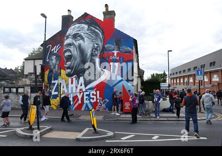 Fans walk past a mural of former Crystal Palace player Wilfried Zaha outside the stadium ahead of the Premier League match at Selhurst Park, London. Picture date: Saturday September 23, 2023. Stock Photo