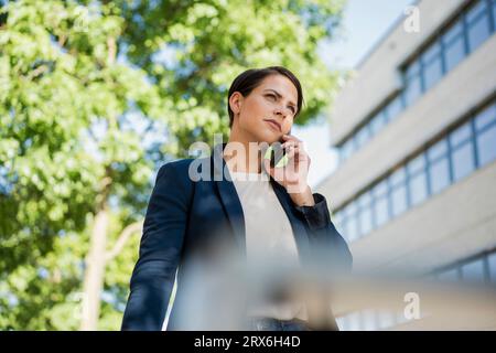 Businesswoman talking on smart phone Stock Photo