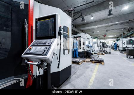 Technicians working and operating machinery in industry Stock Photo
