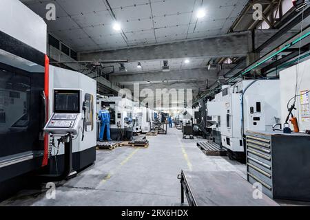 Technicians working and operating machinery in factory Stock Photo