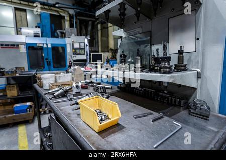 Work tools on table with machinery in industry Stock Photo