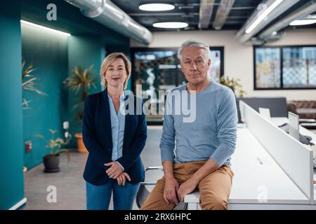 Confident colleagues at work place Stock Photo