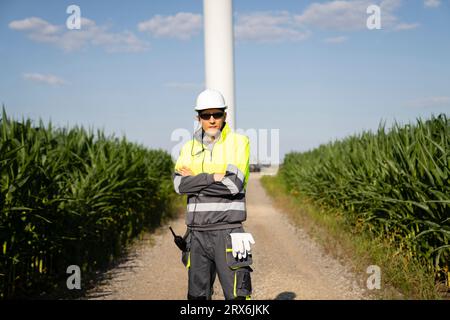 Engineer standing with arms crossed on sunny day Stock Photo