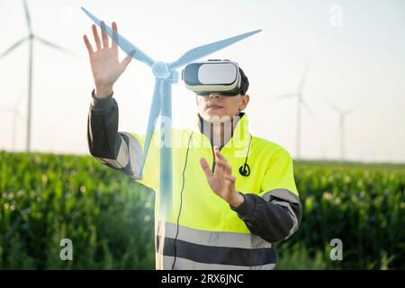 Engineer examining augmented wind turbine model through virtual reality simulator Stock Photo