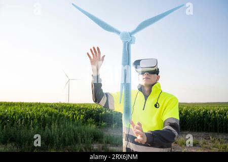 Engineer examining augmented wind turbine model through VR simulator Stock Photo