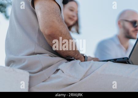 Aesthetic architects collaborating on blueprint in city area, discussing costs, analyzing statistics, solving problems. Urban infrastructure moderniza Stock Photo