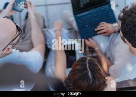 Business Partners Discussing Statistics and Setting New Goals Outdoors on a Sunny Day Stock Photo