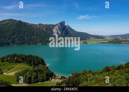 Austria, Upper Austria, Drone view of Mondsee lake with Drachenwand mountain in background Stock Photo