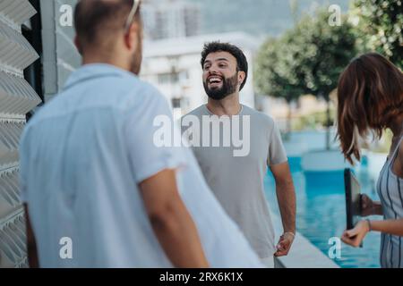 A confident business group discussing projects outdoors, embracing innovation and new opportunities. Together, they analyze data on a tablet, driving Stock Photo