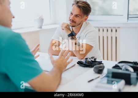 Experienced Doctor Discussing Medical Results with Young Male Patient Stock Photo
