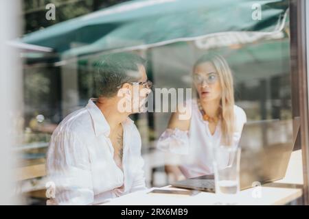 In a corporate office, businesspeople work together discussing business ideas, analyzing statistics, sharing knowledge for successful projects. Stock Photo