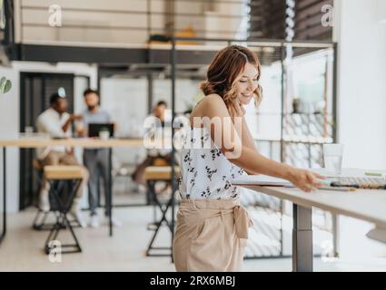 A diverse group of professionals in a business setting, engaged in various activities such as data browsing, networking, and project development. Stock Photo