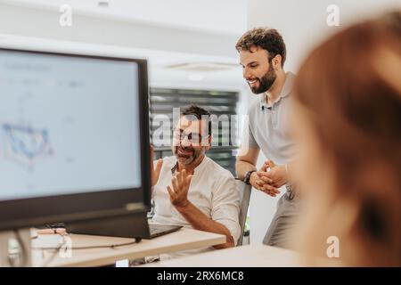 Business partners collaborate, analyze data, plan strategically, and work in a diverse multiracial team towards company growth. Stock Photo
