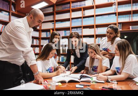 Group of University Students Collaborating on an Educational Project Stock Photo