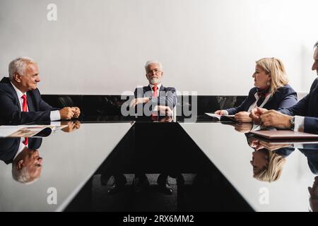 Corporate Team Discussing Strategies for Better Work Results at a Board Meeting Stock Photo