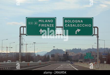 road sign with directions to reach Milan - Florence or Bologna and the crossroads in central Italy with very few cars Stock Photo
