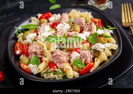 Pasta with tuna, tomatoes and feta cheese. Pasta salad with tuna. Healthy italian food. Healthy dinner. Stock Photo