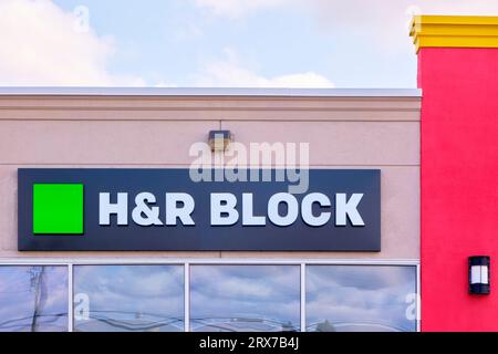 H&R Block sign mounted on a storefront. Stock Photo
